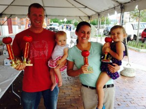 Family farmers holding Tomato Contest trophies